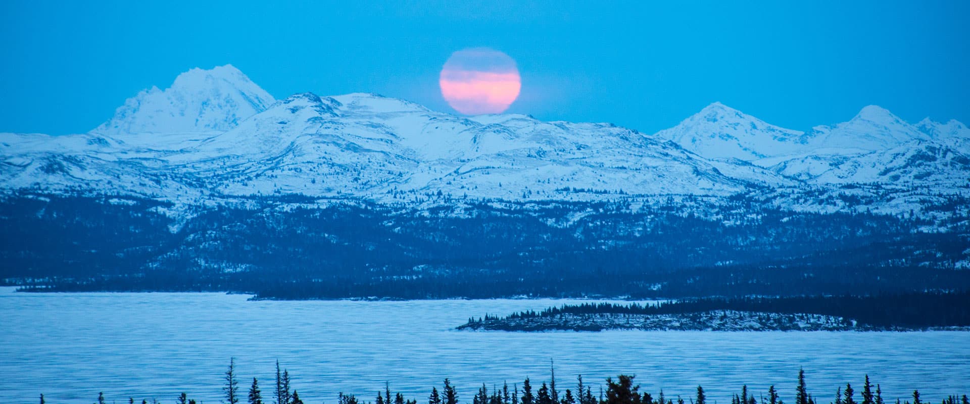 Moon above snowy mountains